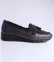 Black women's leather loafer with tassel detail, cushioned footbed and flexible platform sole.