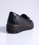 Black women's leather loafer with tassel detail, cushioned footbed and flexible platform sole.