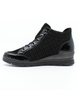 Black women's leather ankle sneaker with mixed textures, side zipper and cushioned footbed.