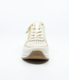 Cream women's leather sneaker with perforated upper, side zipper and wedge sole.