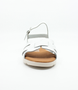 White girls' leather sandal with crossover straps, adjustable ankle strap and cushioned footbed.