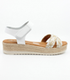 White girls' leather sandal with woven crossover straps, ankle strap and cushioned footbed.