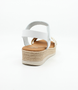 White girls' leather sandal with woven crossover straps, ankle strap and cushioned footbed.