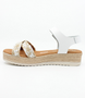 White girls' leather sandal with woven crossover straps, ankle strap and cushioned footbed.