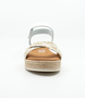 White girls' leather sandal with woven crossover straps, ankle strap and cushioned footbed.