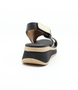 Black women's textured leather sandal with crossover straps, slingback strap and cushioned footbed.