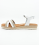 White girls' leather sandal with crossover straps, woven detailing, buckle fastening and cushioned footbed.