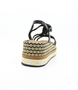 Black women's raffia platform sandal with braided straps, woven midsole and adjustable ankle strap.