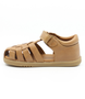 Caramel unisex leather sandal with closed heel, woven straps and hook-and-loop fastening.
