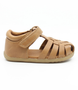 Caramel unisex leather sandal with closed heel, woven straps and hook-and-loop fastening.