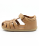 Caramel unisex leather sandal with closed heel, woven straps and hook-and-loop fastening.