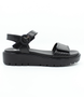 Black women's leather sandal with Velcro fastening, padded insoles and platform sole.