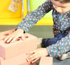 child stacking our red foam bricks