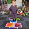 boy playing on our sensory floor tiles