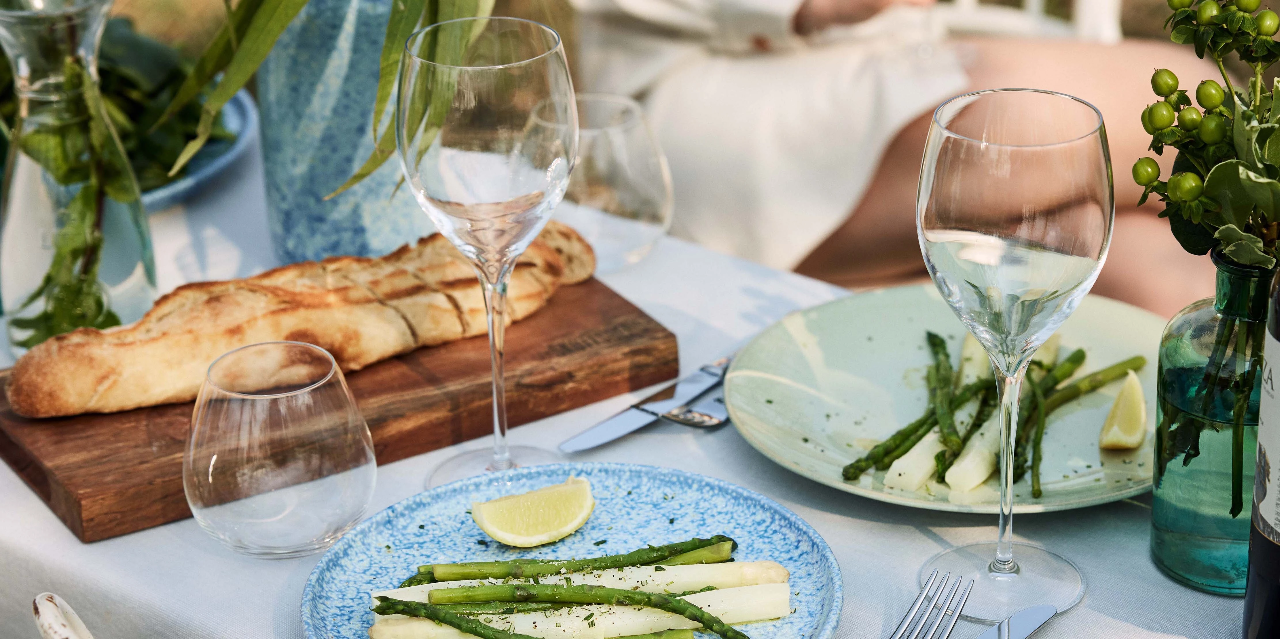 Complete table setting with wine glasses