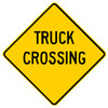 Yellow sign, says "Truck Crossing" in black letters Yellow sign, says "Truck Crossing" in black letters