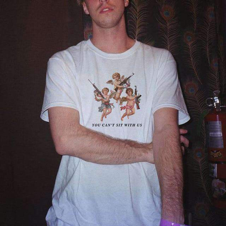you can't sit with us white tee with the prints of baby angels holding guns you can't sit with us white tee with the prints of baby angels holding guns