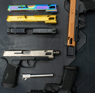 Sig P365 FUSE with True Precision Threaded barrel, and slide, laid out on a black background with other slides and barrels