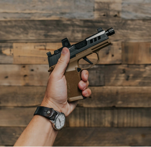 A Sig P365 XL with True Precision threaded barrel in black nitride and Axiom slide in stealth grey being held against a wooden background.