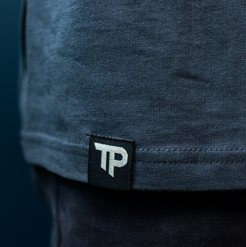True Precision TRUE Blue "Not so Basic T-Shirt",  Hem Tag with "TP" initials and blue background.