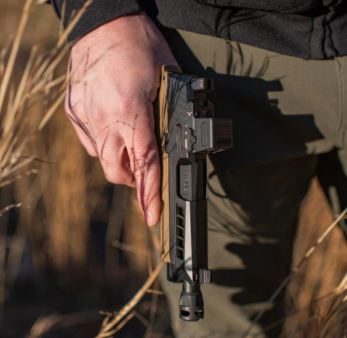True Precision Sig Sauer P365 XL with Black barrel, slide, and Micro Compensator being held in a field. True Precision Sig Sauer P365 XL with Black barrel, slide, and Micro Compensator being held in a field.