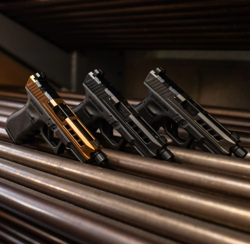 3 Glock 19s with True Precision barrels and slides on metal bars staggered