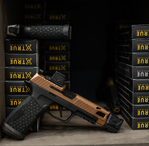 Sig P365 FUSE with True Precision threaded barrel and True-lock Compensator, next to packaged barrel boxes