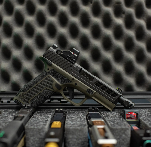 True Precision Springfield Hellcat with black threaded barrel and micro comp, in a gun case.