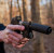 A Sig P365 with a True Precision threaded duty barrel in stainless, in the woods with a black suppressor
