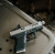 Glock 43 with Satin Stainless Threaded True Precision barrel on a grey metal background.
