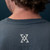 Back of man wearing True Precision TRUE Blue "Not so Basic T-Shirt", with True Precision logo and blue background.