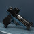 A Sig P365 XL with True Precision non-threaded satin stainless barrel and Axiom black nitride slide sitting on a silver metal beam with blue background