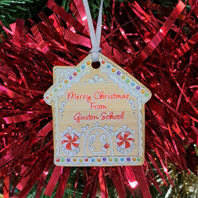 Wooden Gingerbread House School printed with customised school text hanging on a Christmas tree