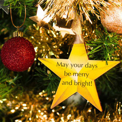 Wooden Star Christmas Decoration - gold-coloured star with text saying 'may your days be merry and bright', hanging on a Christmas tree