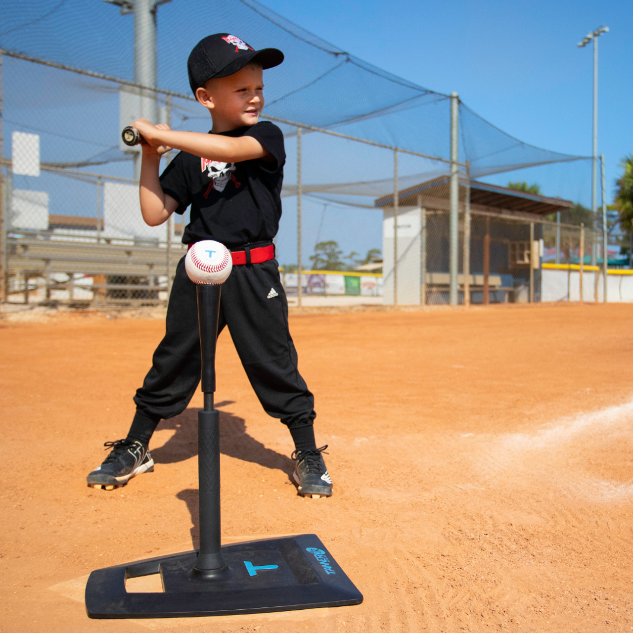 Child baseball player focused ready to bat. Kid holding a baseball