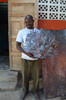 Haitian Artist Bernard Louis holding a Freda heart