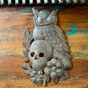 Day of the Dead-inspired sugar skull and floral design on a hand-cut Haitian metal panel