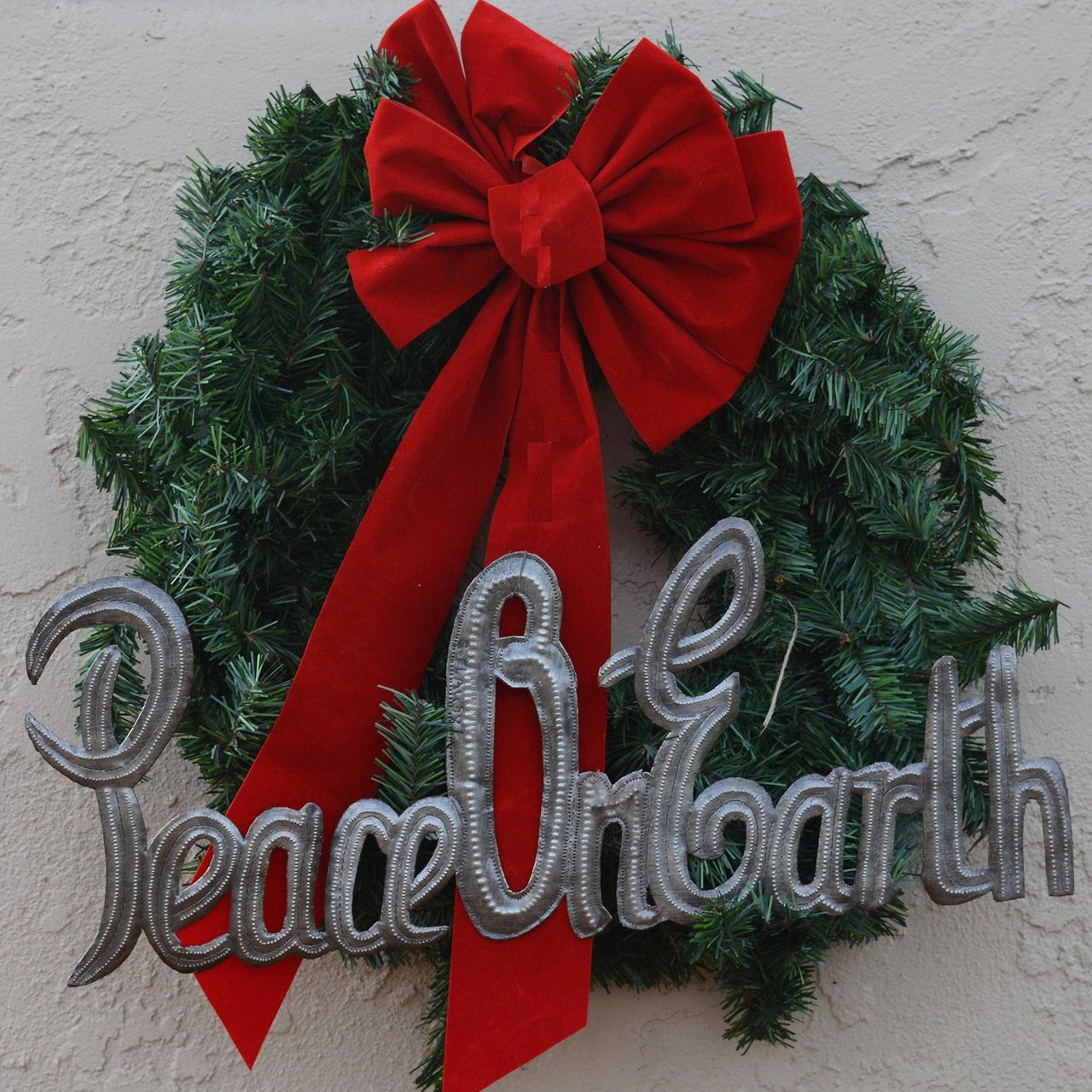 The message "Peace on Earth," crafted from recycled steel in the style of Haitian metal art The message "Peace on Earth," crafted from recycled steel in the style of Haitian metal art