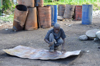 flattening metal drums for Haiti metal art