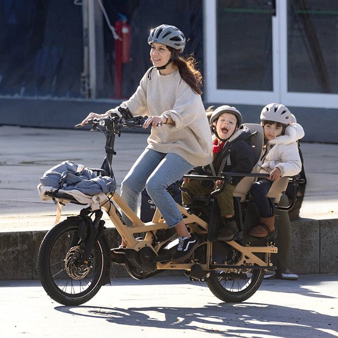 Family riding a Tern cargo e-bike with two children