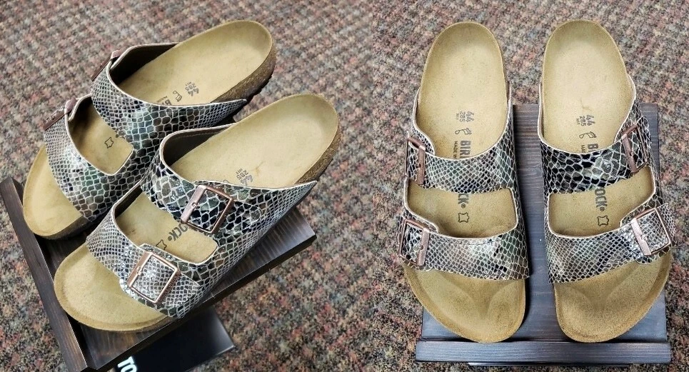 Snakeskin-patterned Birkenstock sandals with two adjustable buckle straps and cork footbeds, shown from two angles.