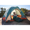 Woman sitting in Kelty Discovery Basecamp 4 tent