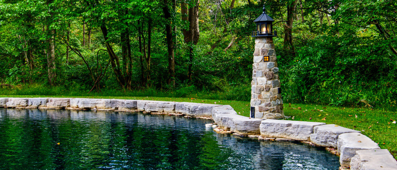 Amish handcrafted stone lighthouse on lake shore