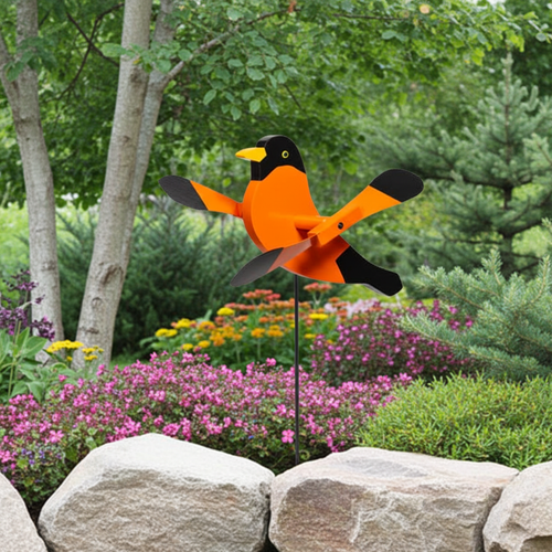 Amish handcrafted lawn decor whirlygig garden stake - Oriole, pictured in backyard rock garden