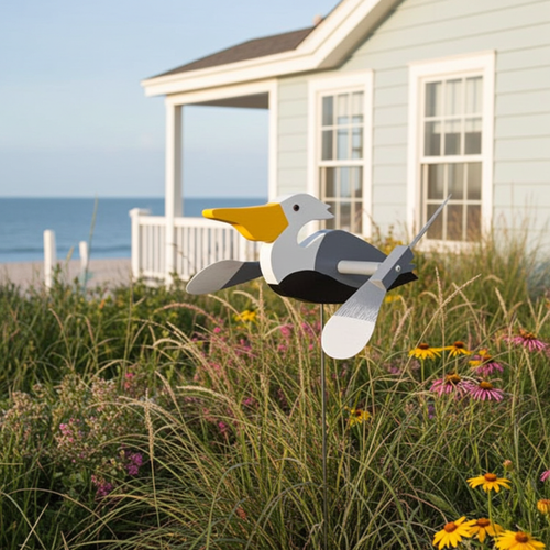 Amish handcrafted lawn decor whirlygig garden stake - Pelican, pictured in beach house flower bed