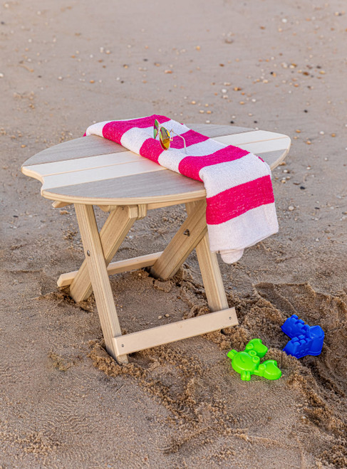 Amish handcrafted poly outdoor furniture, surfboard style folding end table, on beach with towel and sand toys