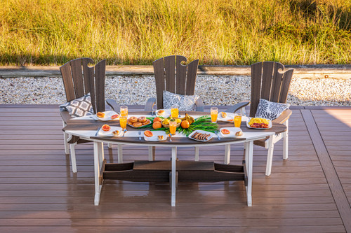 Surf-Aira 8 foot poly dining table and Ocean Wavz chairs finished in brazilian walnut and white, pictured on a seaside deck.