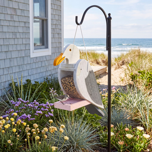 Amish crafted wood bird feeder in seagull design pictured in coastal home flowerbed