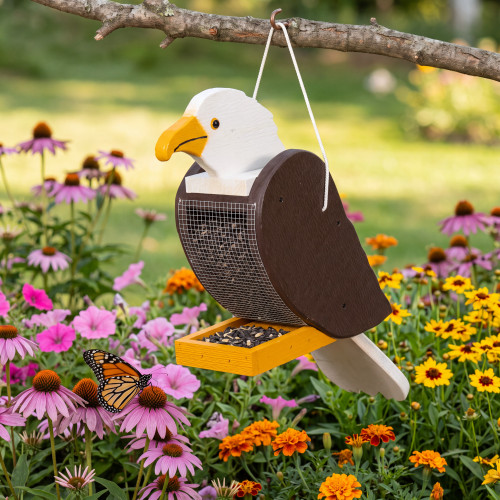 Amish crafted wooden bird feeder in eagle design, pictured in a flower garden
