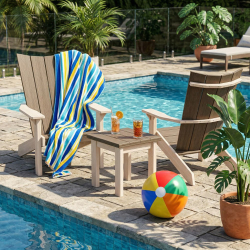 Poly side table and adirondack chairs from the Skyward collection by Finch in a poolside setting.